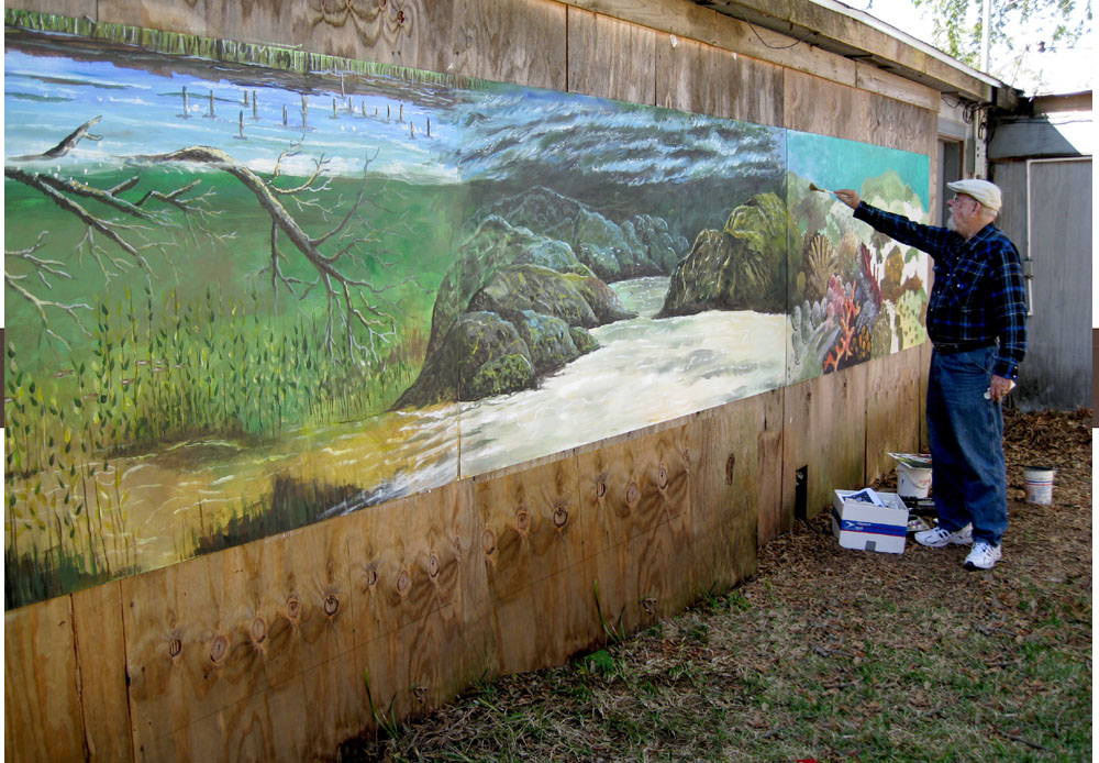 Ken "the Dauber" Pridgeon puts the finishing touches on the new mural for the Eddie V. Gray Wetlands Center.